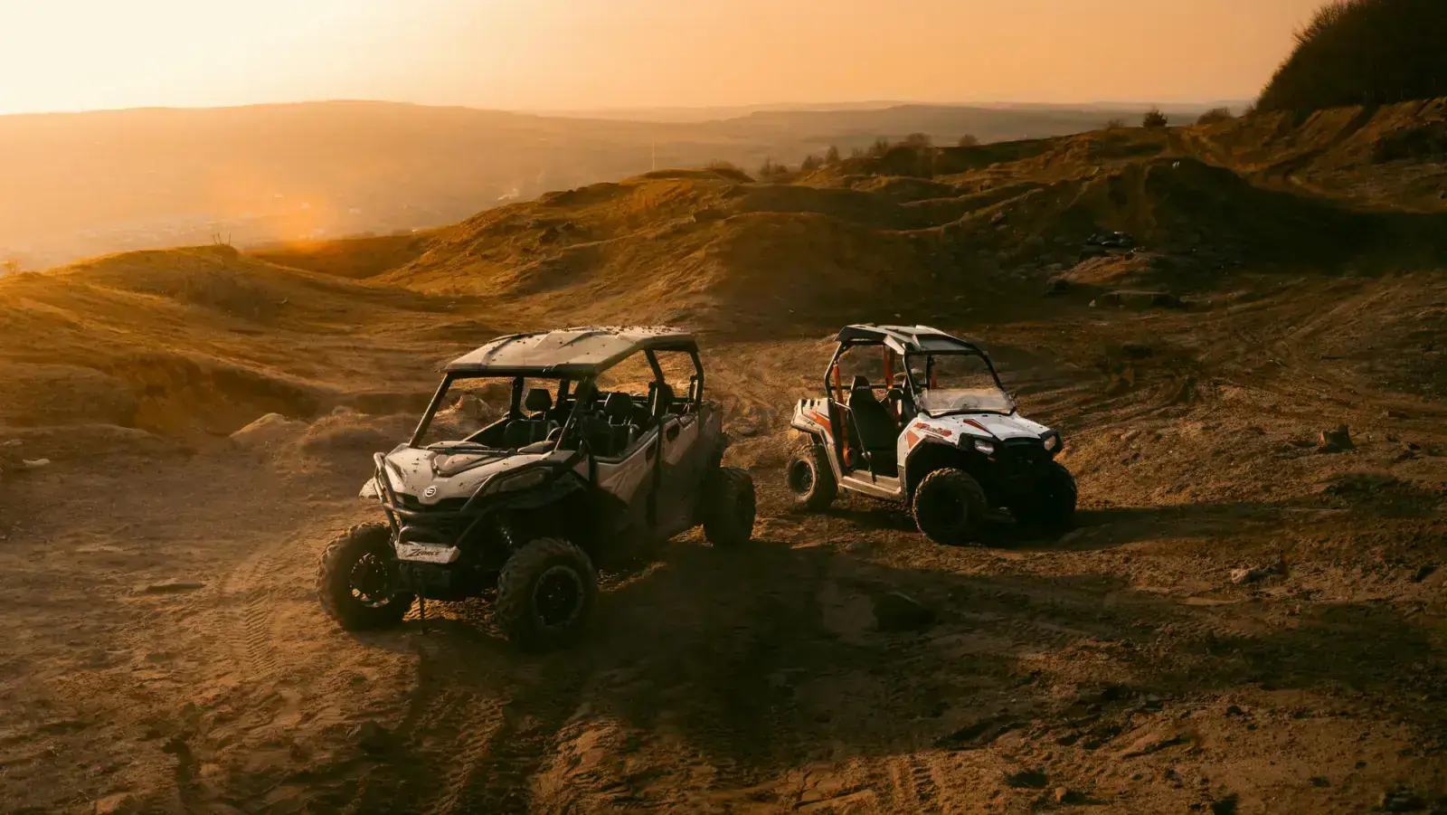 BuggyZone off-road vehicles on dusty terrain at sunset - Adventure awaits